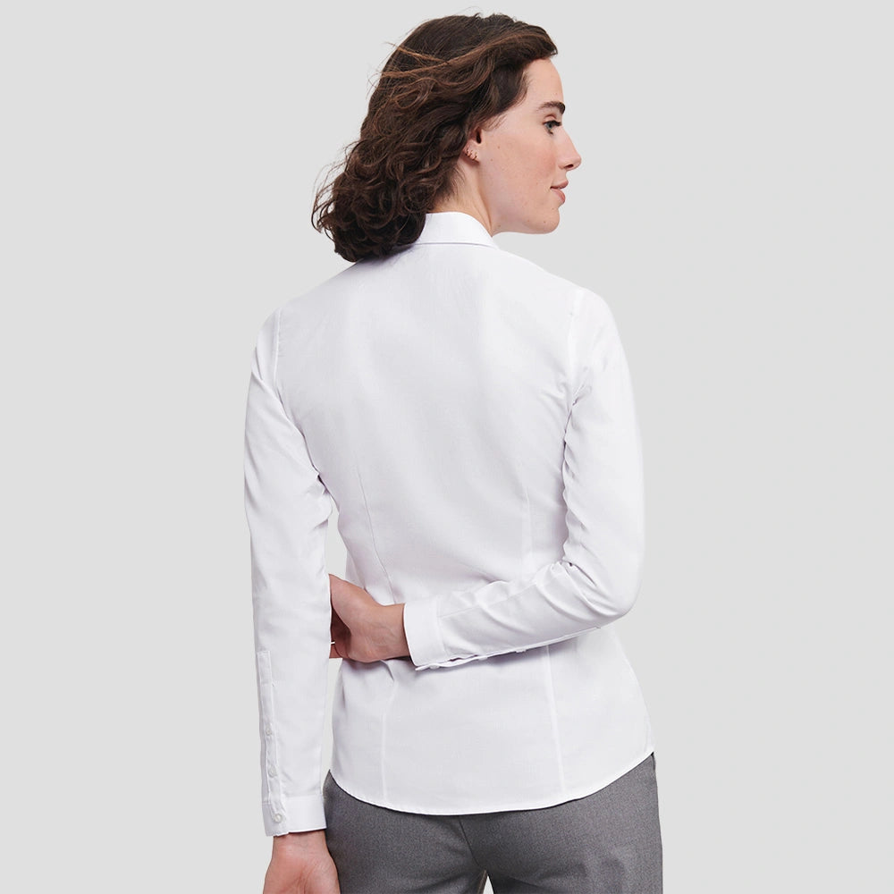 Rear view of Model wearing the Russell Collection Ladies Long Sleeve Herringbone Shirt in White