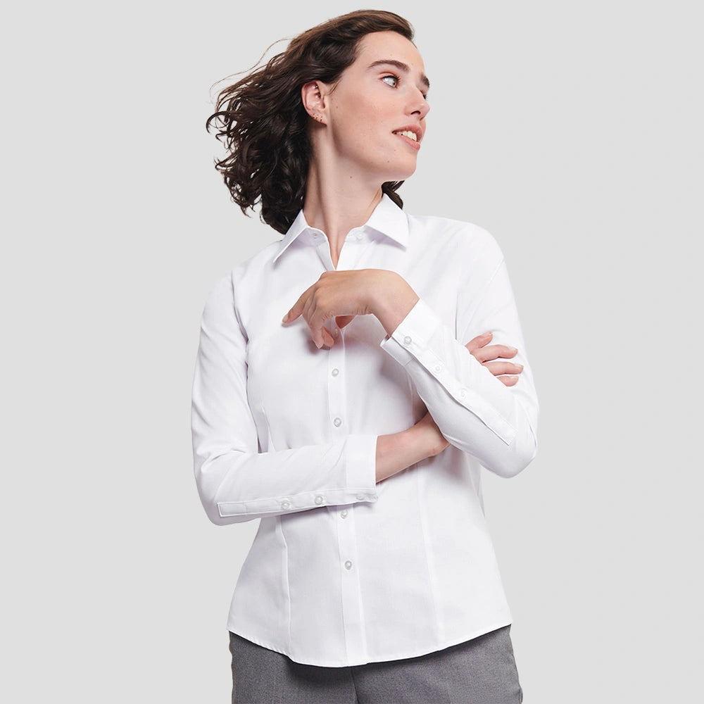 Model wearing the Russell Collection Ladies Long Sleeve Herringbone Shirt in White