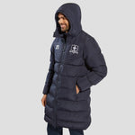 Model wearing the The Chadwick Chevron Puffer Coat in Navy with the hood up.