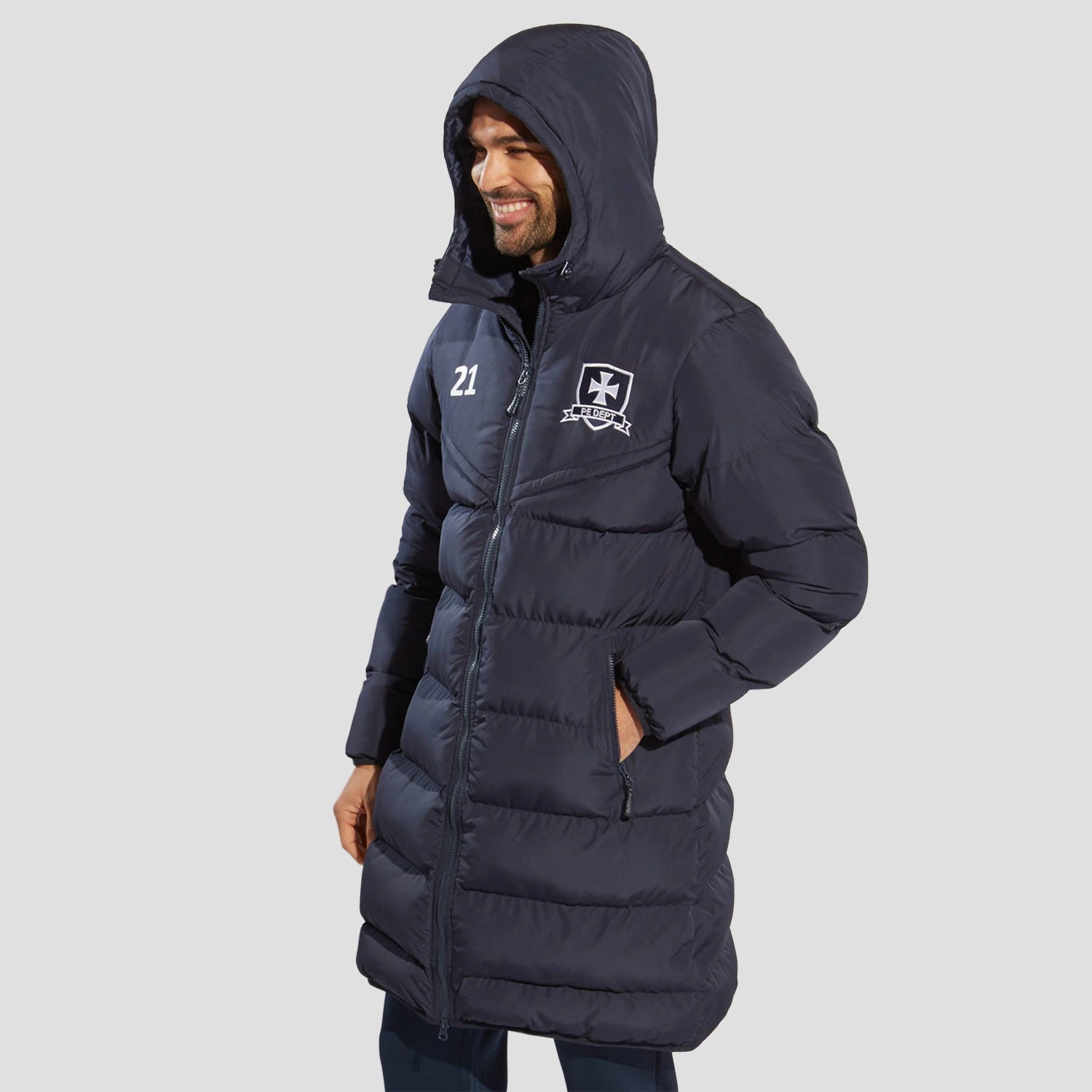 Model wearing the The Chadwick Chevron Puffer Coat in Navy with the hood up.
