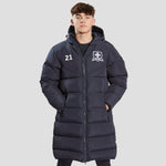 Model wearing the the Chadwick Teamwear Youth Chevron Puffer Coat in Navy.