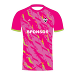 Pink T20 cricket shirt with green accents and a sponsor logo front view