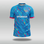 Electric blue T20 cricket shirt with pink and yellow pattern and 'SPONSOR' text