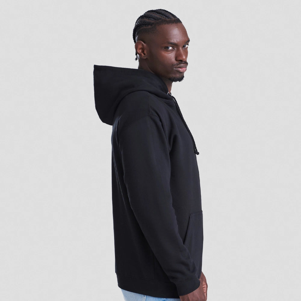Man wearing a black AWDIS Just Hoods JH001 College Hoodie on a light gray background