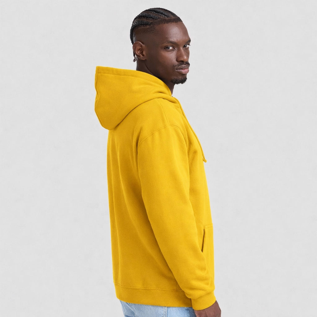 Man wearing a mustard AWDis JH001 College Hoodie