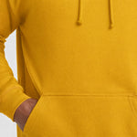 Close-up of a mustard AWDis JH001 College Hoodie pocket