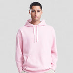 Person wearing a pink AWDis Varsity Hoodie against a plain background
