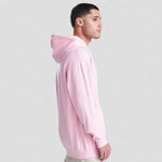 Person wearing a pink AWDis Varsity Hoodie on a light gray background