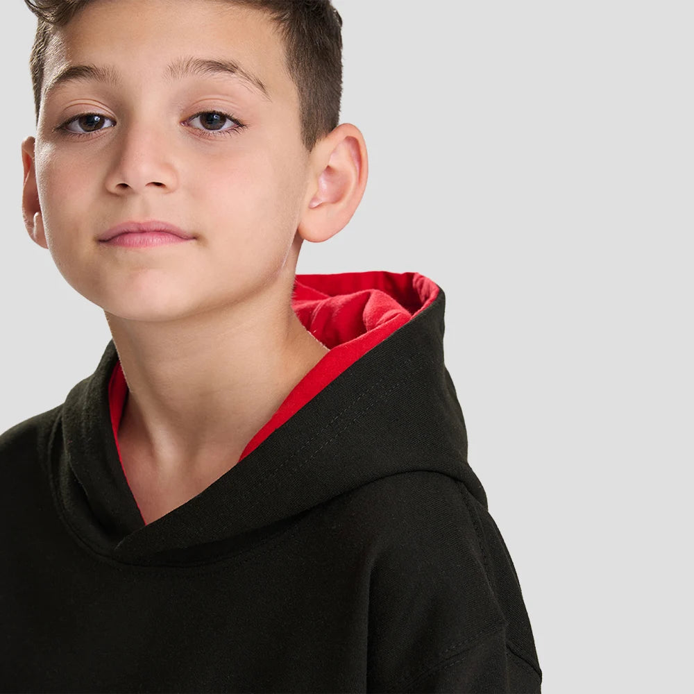 Close-up of Model wearing the AWDis Kids Varsity Hoodie JH003B in Jet Black / Fire Red
