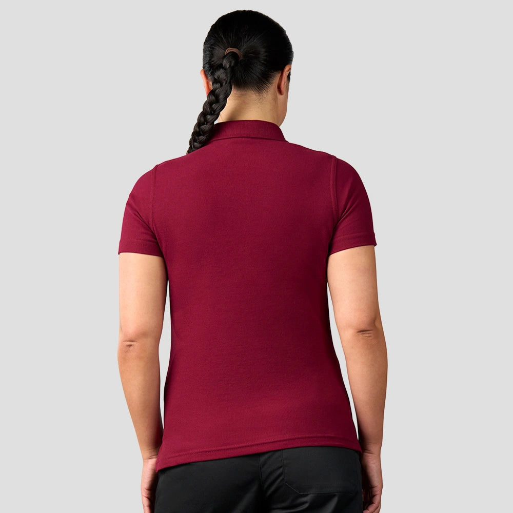 Rear view of model wearing the Pro RTX Ladies Pro Piqué Polo Shirt in Burgundy