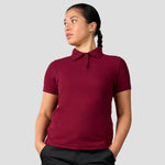 Rear view of model wearing the Pro RTX Ladies Pro Piqué Polo Shirt in Burgundy