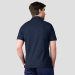 Rear view of Model wearing RX109 Pro Wicking Piqué Polo Shirt in Navy