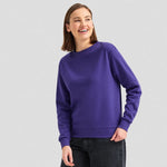 A model wearing a Uneek Ladies Deluxe Crew Neck Sweatshirt UC211