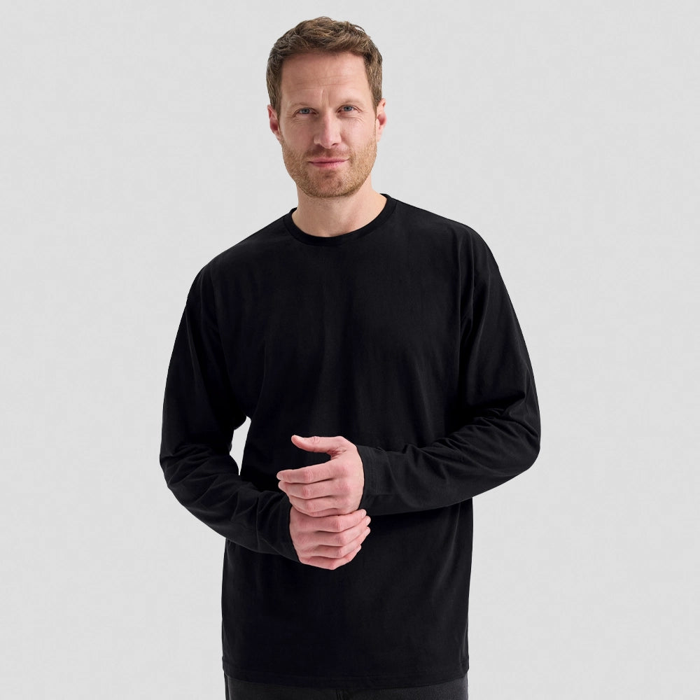 A model wearing a Uneek Long Sleeve Classic T-Shirt UC314