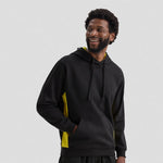Man wearing a black Uneek Two Tone Hooded Sweatshirt UC517 with yellow accents