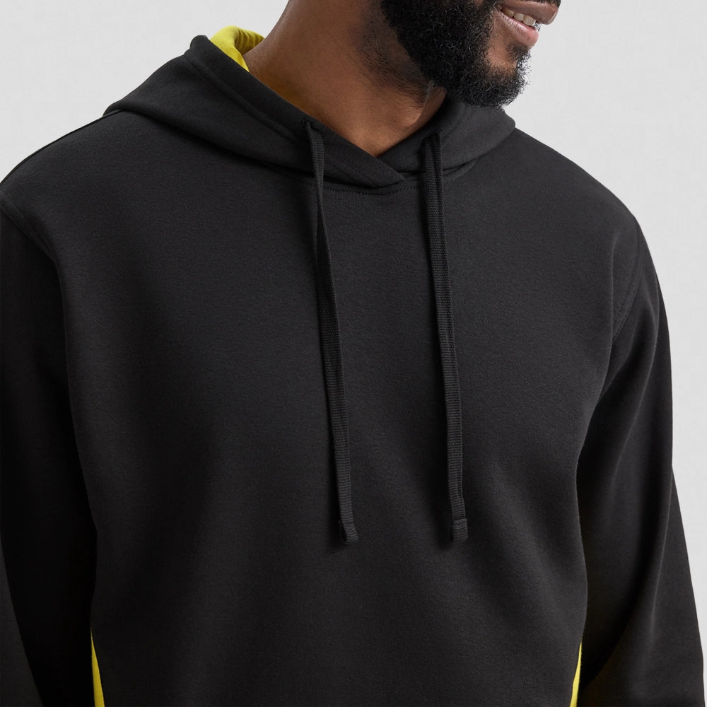 Person wearing a black Uneek Two Tone Hooded Sweatshirt UC517 with yellow accents
