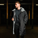 Model wearing black fleece lined changing robe