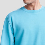Close-up of Model wearing the JH030 AWDis Sweatshirt in Blue