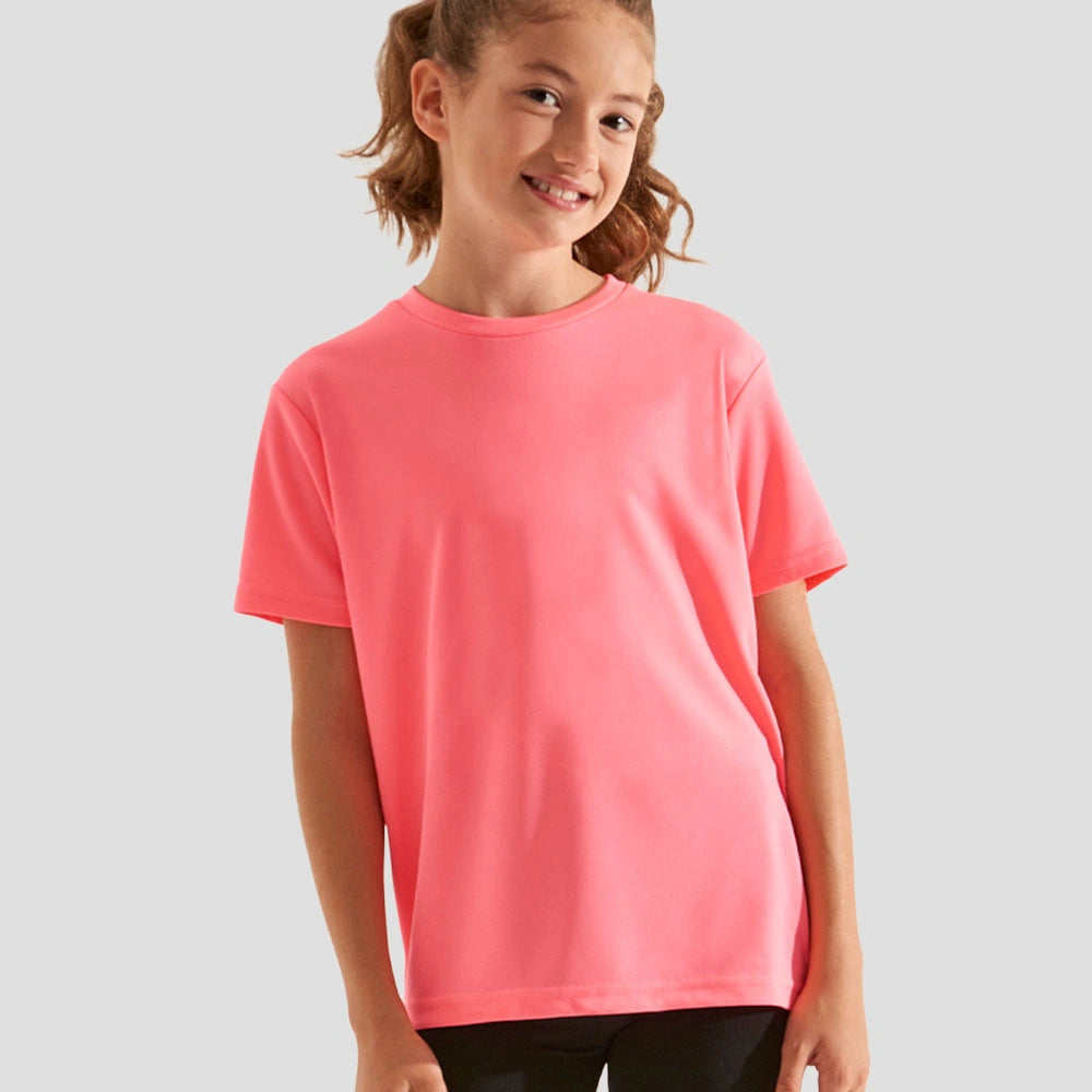 Model wearing the AWDis Kids Cool T-Shirt JC001 in Electric Pink