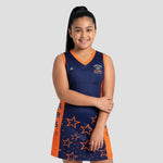 Model wearing Cheshire Stars Netball Dress - Junior