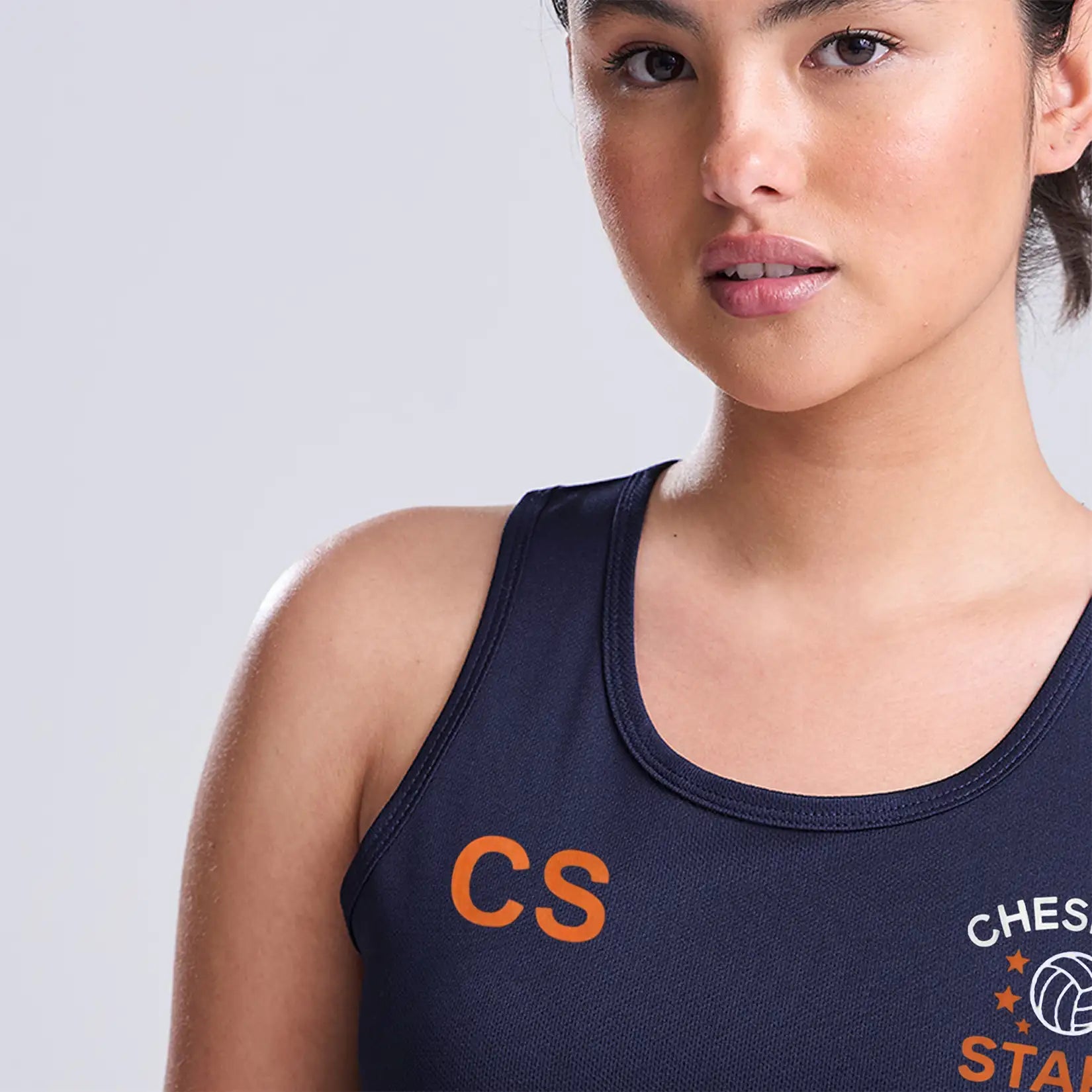 Model wearing the Cheshire Stars Netball Club Ladies Vest (Navy) - Adult