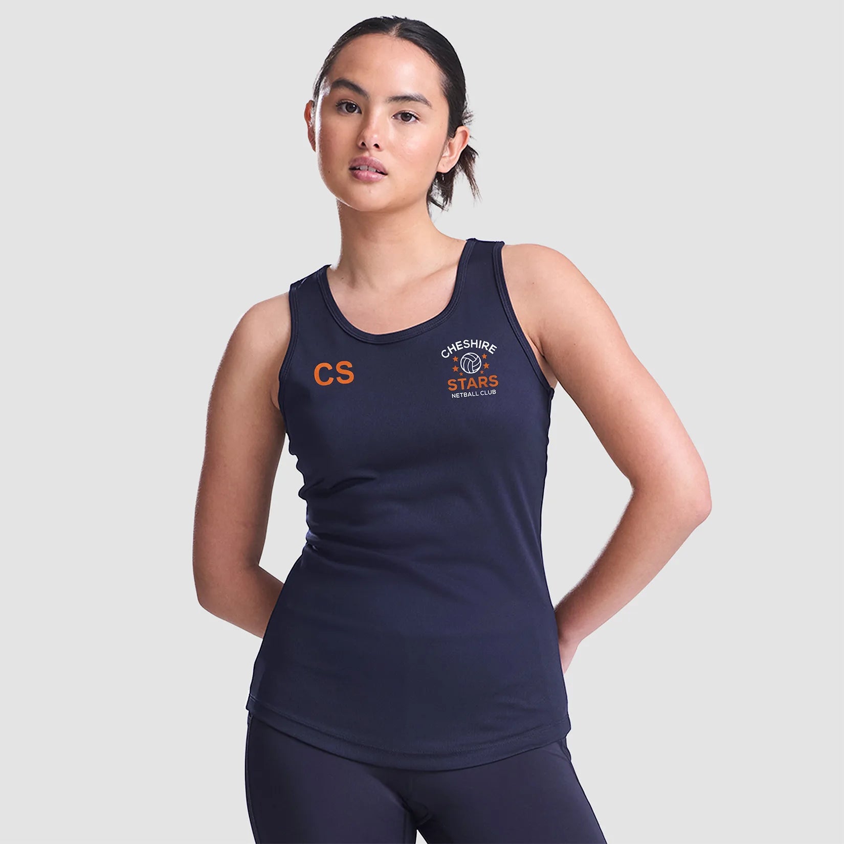 Model wearing the Cheshire Stars Netball Club Ladies Vest (Navy) - Adult