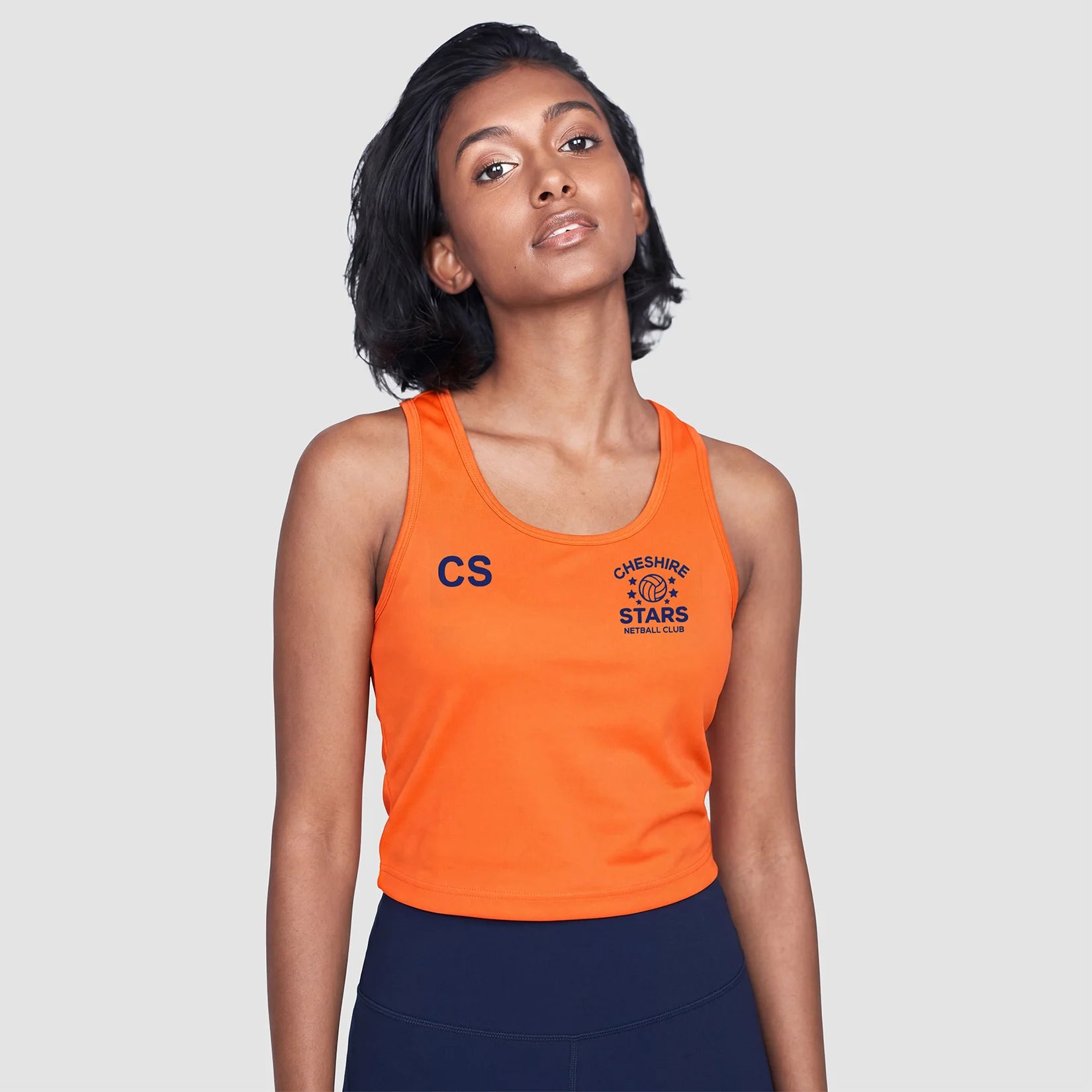 Model wearing the Cheshire Stars Netball Club Ladies Vest (Orange) - Adult