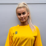 Female Model wearing the Stuart Surridge Dual Games Shirt in Amber