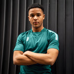 Man wearing the Surridge Sport Dual Games Shirt in Bottle Green