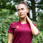 Model wearing the Stuart Surridge Dual Games Shirt - Women's Fit - Maroon