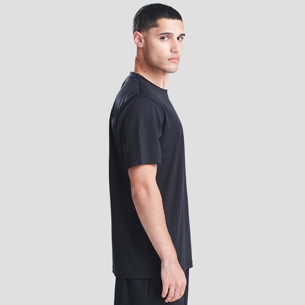 Side view of Model wearing the AWDis Cool T-Shirt JC001 in Jet Black