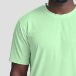 Close-up of Model wearing the AWDis Cool T-Shirt JC001 in Green