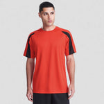 Person wearing a red sports jersey with black sleeves on a white background