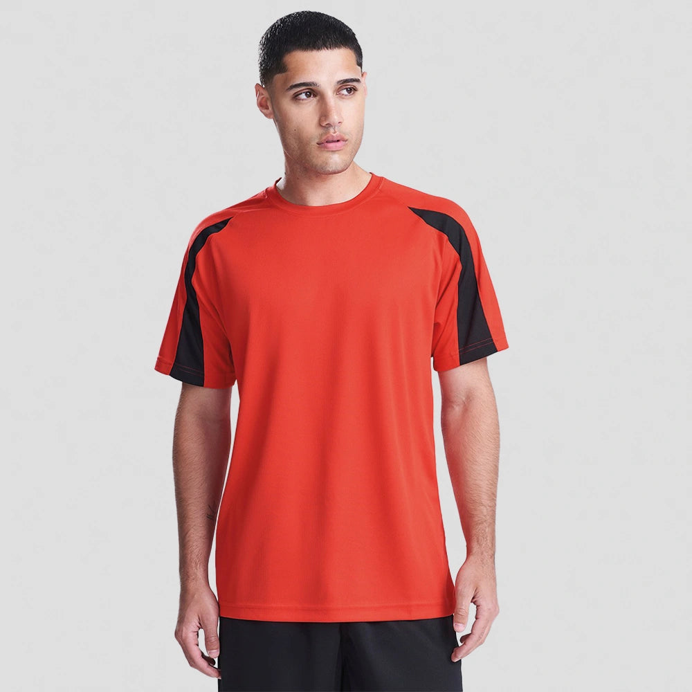 Person wearing a red sports jersey with black sleeves on a white background