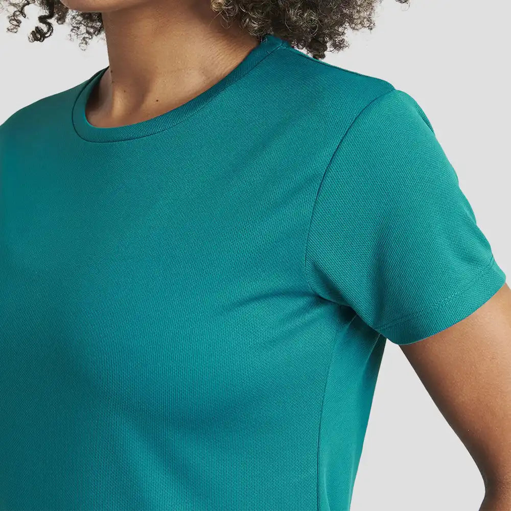 Close-up of Model wearing the AWDis Ladies Cool T-Shirt JC005 in Jade Green