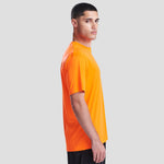 Side view of Model wearing the JC020 AWDis Cool Smooth T-Shirt in Electric Orange