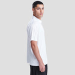 Side view of Model wearing the AWDis Cool Smooth Polo Shirt JC021 in Arctic White
