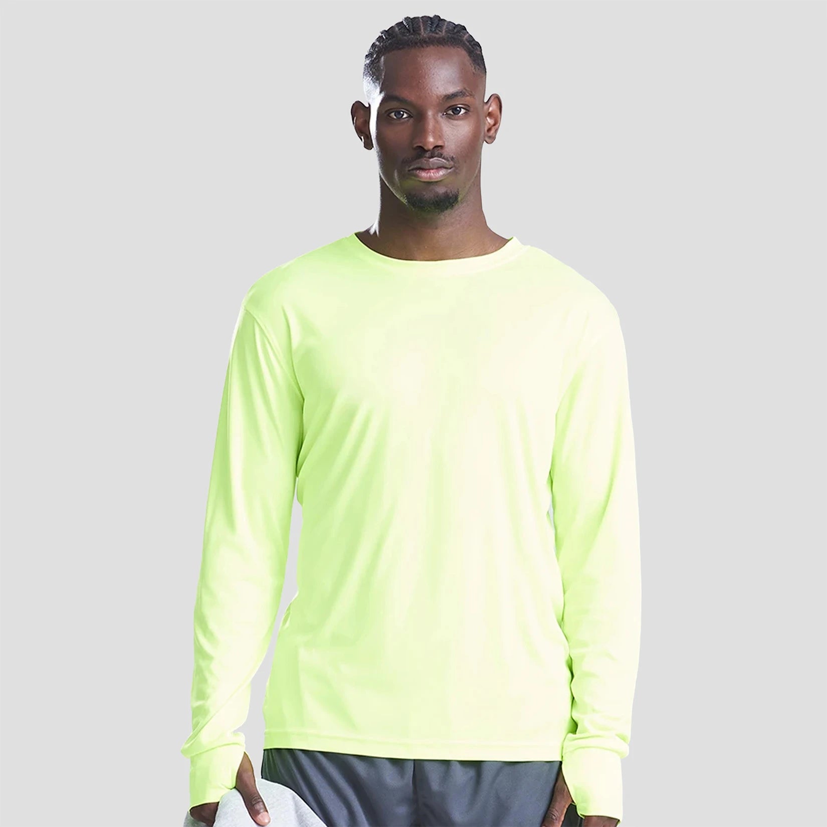 Model wearing the AWDis Cool Long Sleeve Active T-Shirt JC023 in Electric Yellow