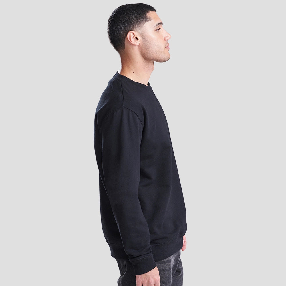 Side view of Model wearing the JH030 AWDis Sweatshirt in Deep Black