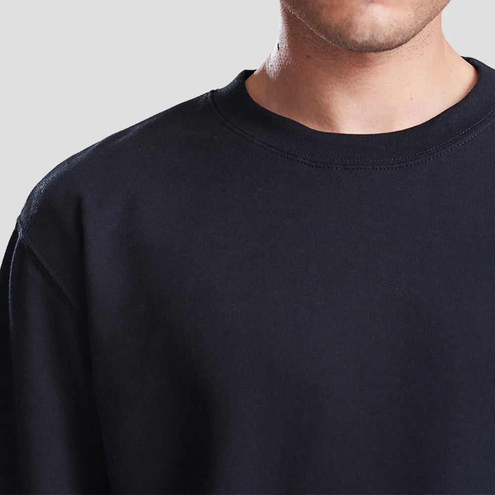 Close-up of model wearing the JH030 AWDis Sweatshirt in Deep Black