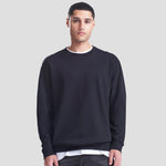Model wearing the JH030 AWDis Sweatshirt in Deep Black