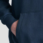 Model wearing the JH120 AWDis Heavyweight Signature Hoodie in New French Navy, front pocket close-up