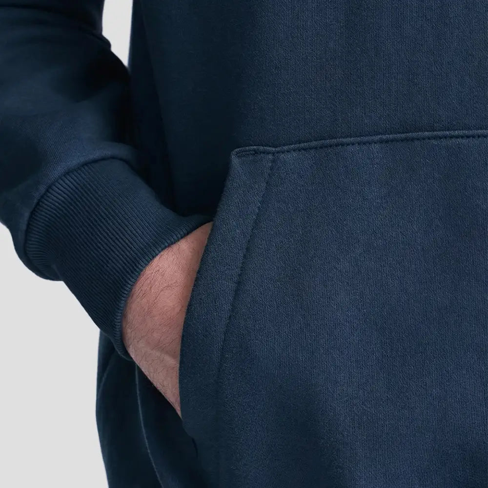 Model wearing the JH120 AWDis Heavyweight Signature Hoodie in New French Navy, front pocket close-up