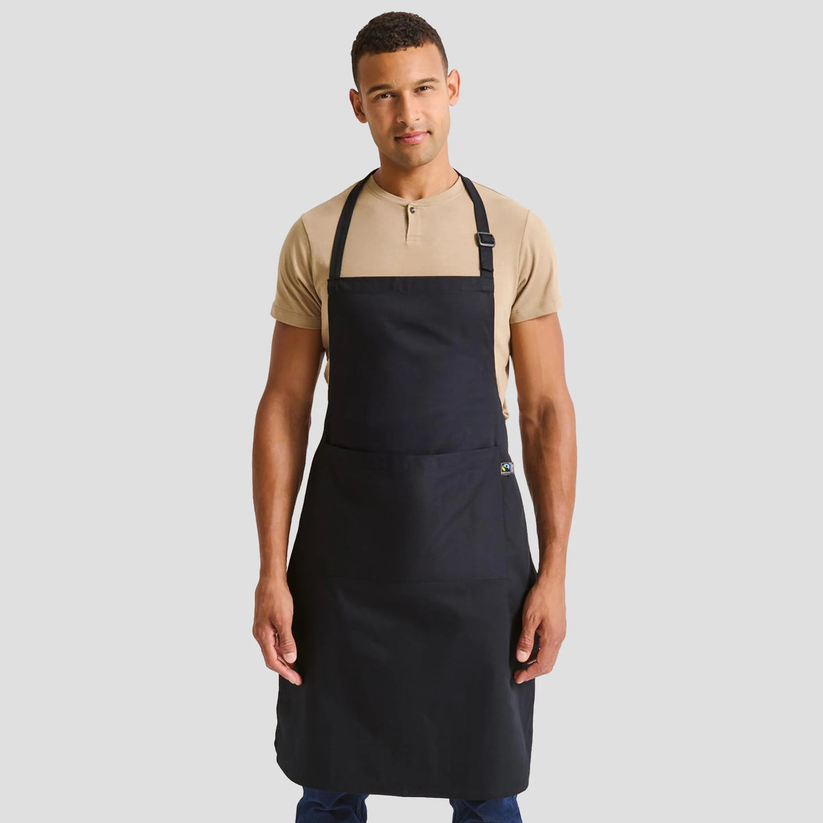 Model wearing the Premier Fairtrade Organic Cotton Bib Apron PR112.