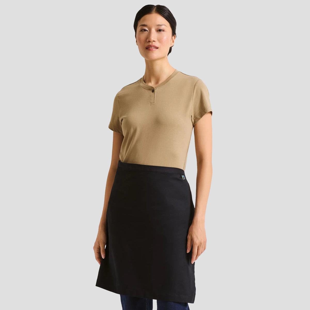 Model wearing the Premier Fairtrade Organic Cotton Waist Apron PR114.