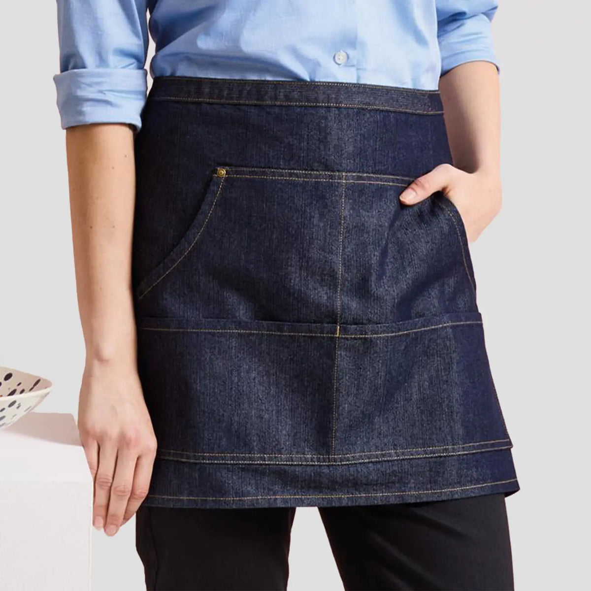Close-up of model wearing the Premier Denim Waist Apron PR125.