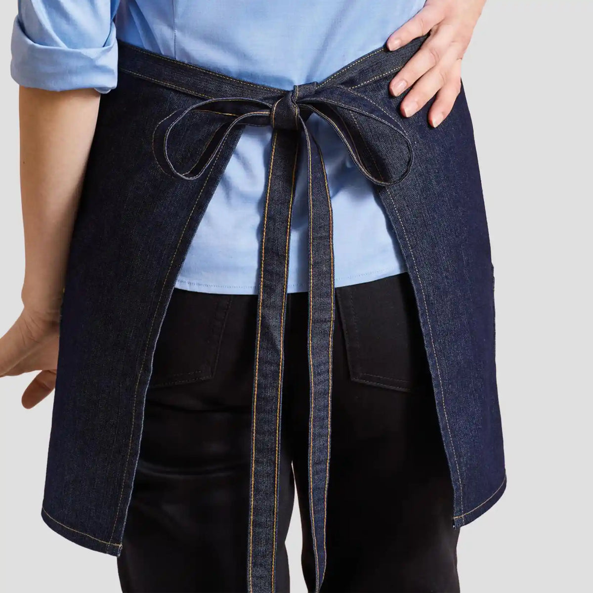 Rear view of model wearing the Premier Denim Waist Apron PR125.