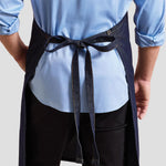 Rear view of model wearing the Premier Denim Bib Apron PR126.