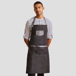 Model wearing the Premier Domain Bib Apron PR127.