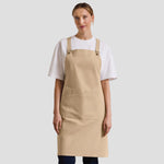 Model wearing the Premier Cross Back Barista Bib Apron PR129.